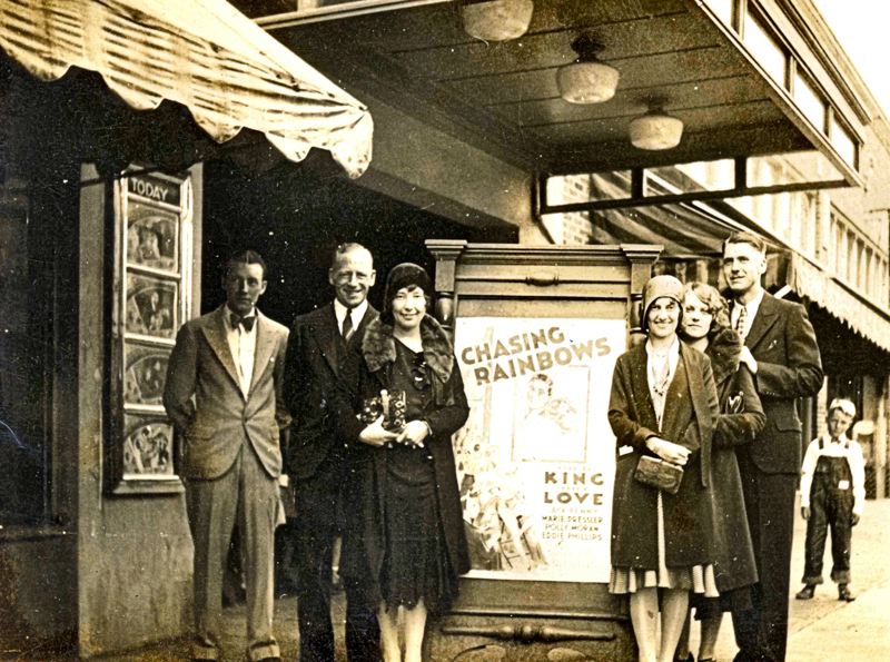 image of several people standing in front of the moreland theater marquee