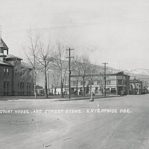 Photo looking across the street scene in Enterprise, especially featuring the court house across the street from the theatre
