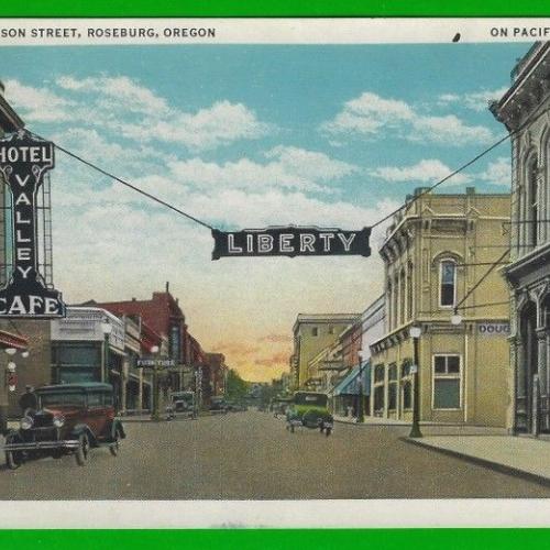 Postcard image of the Liberty theater and Jackson St. in Roseburg, Oregon.