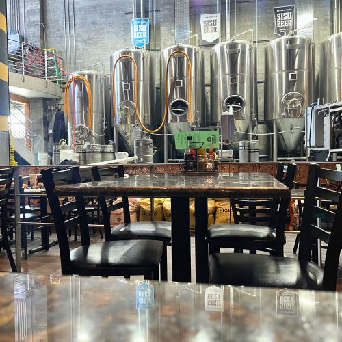The tables and stage/kegs in the main seating area of the Times