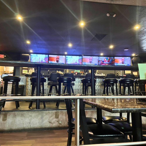The bar and televisions at the back of the restaurant in the Times