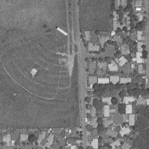Black-and-white satellite image of the closed and overgrown Cascade Drive-In Theatre, taken in 1994.