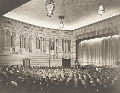 Interior photo of the bagdad showing the stage curtain and part of the seating area