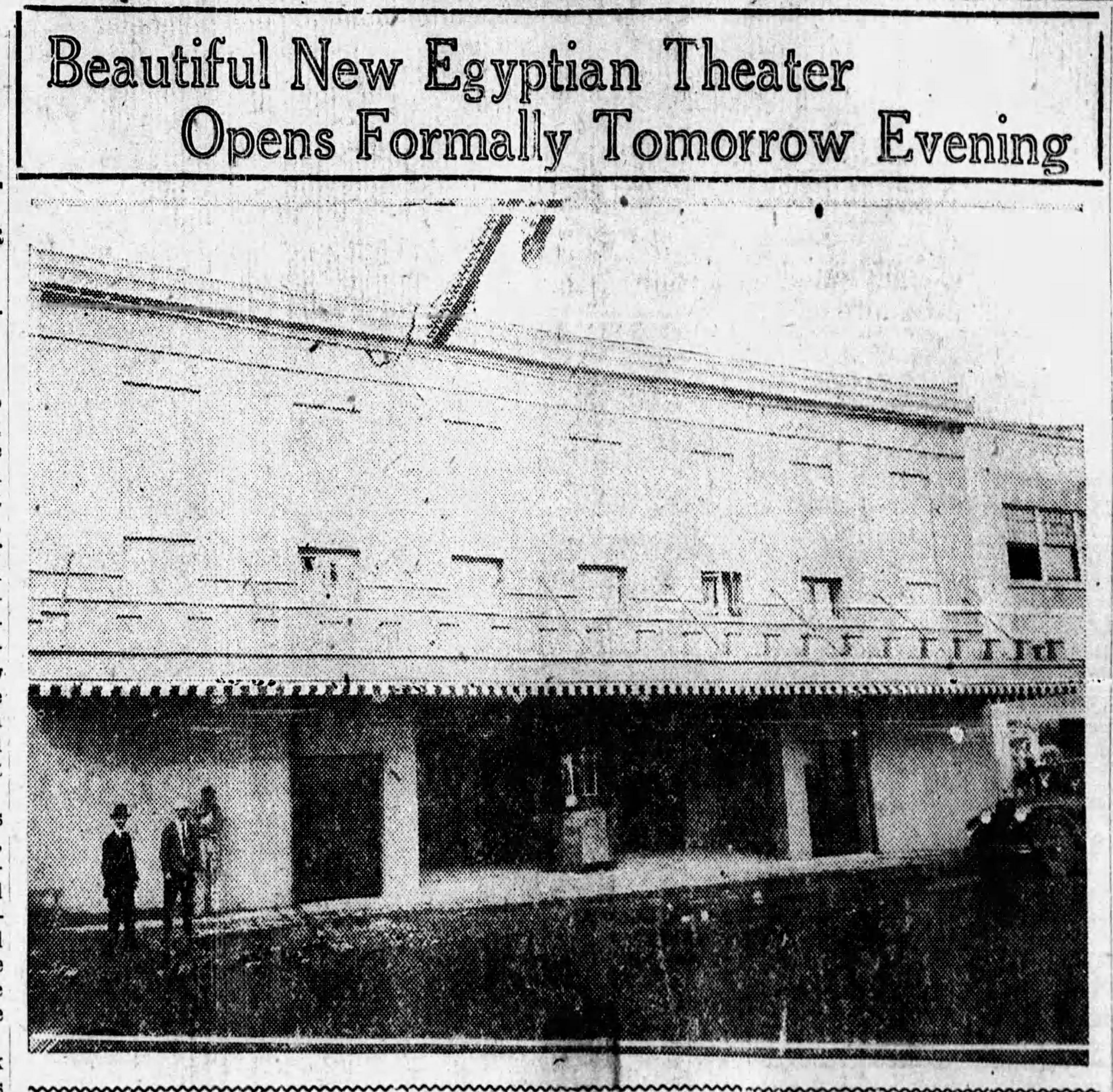 Newspaper clipping with image of the front of the theater